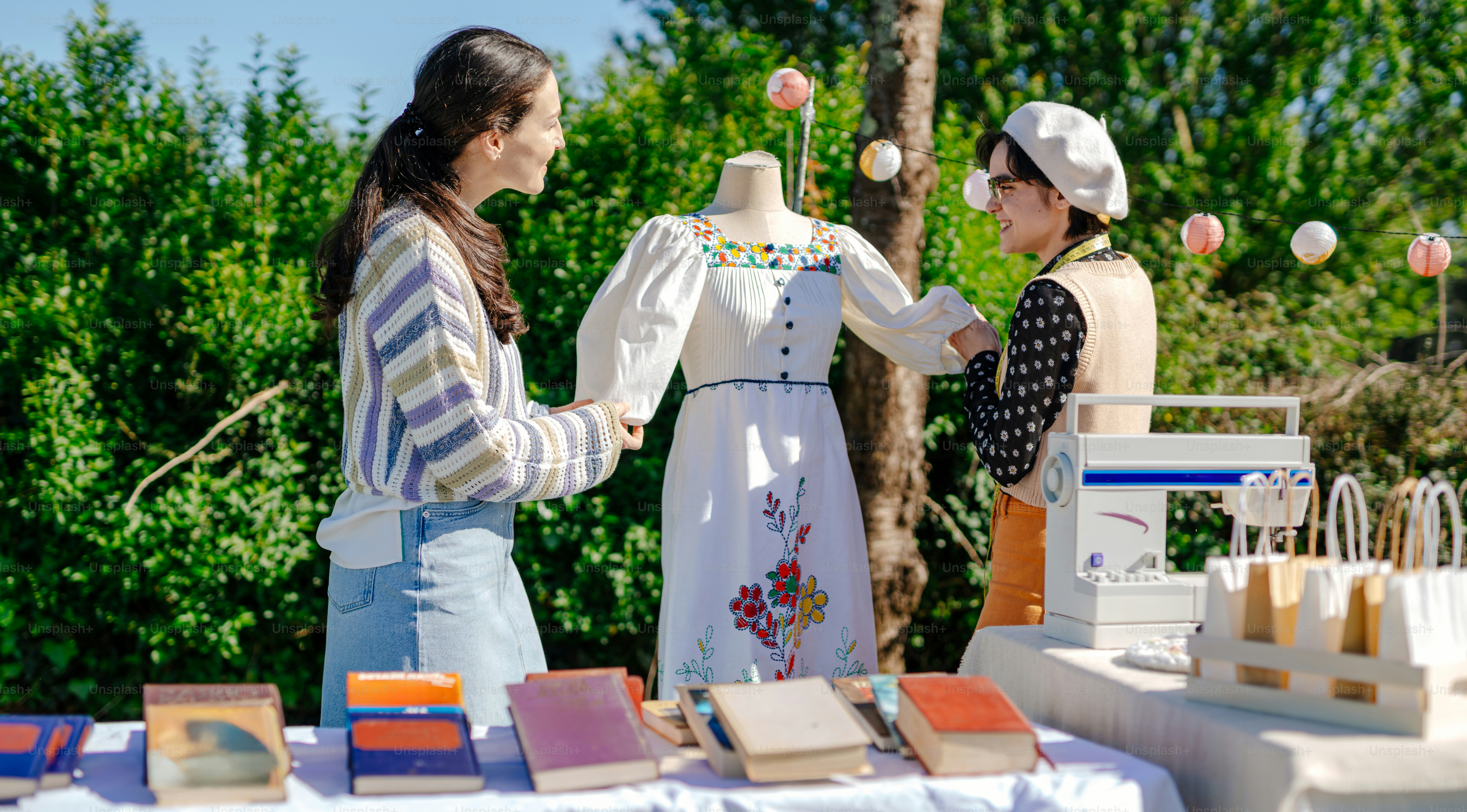 a couple of women standing next to each other near a table