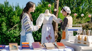 a couple of women standing next to each other near a table