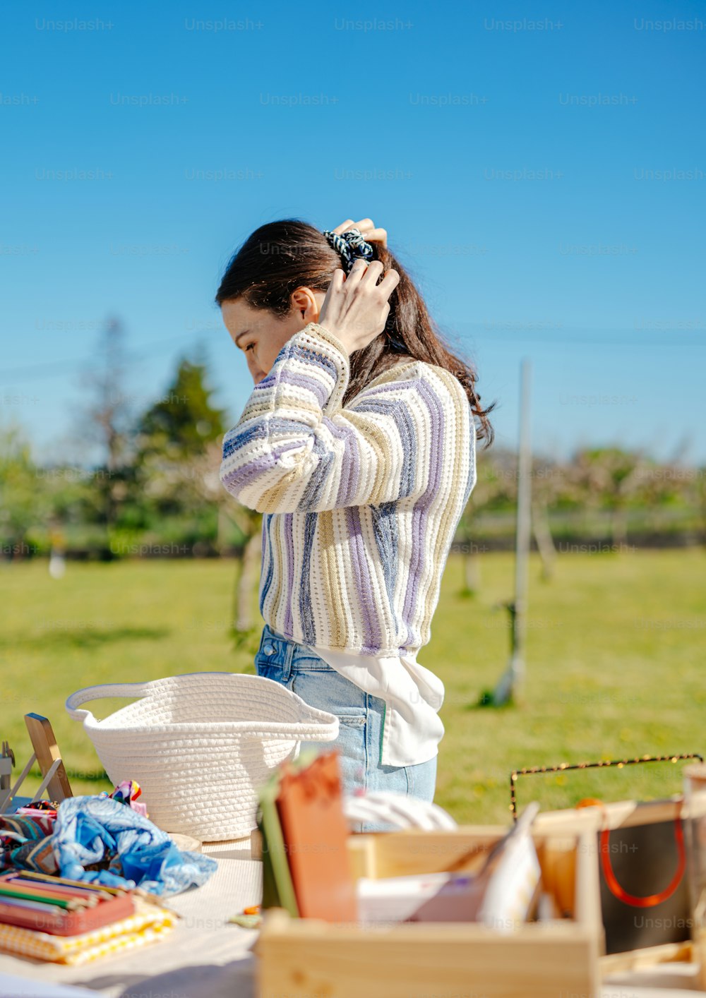 a woman standing at a table with a bowl of food