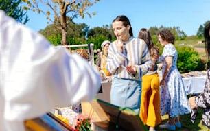 a group of people standing around a table