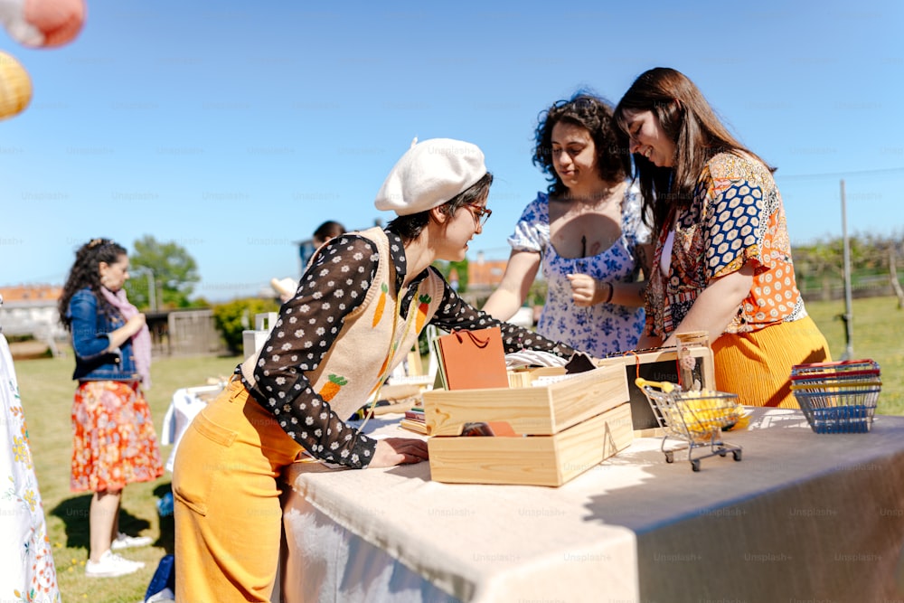 a group of women standing around a table