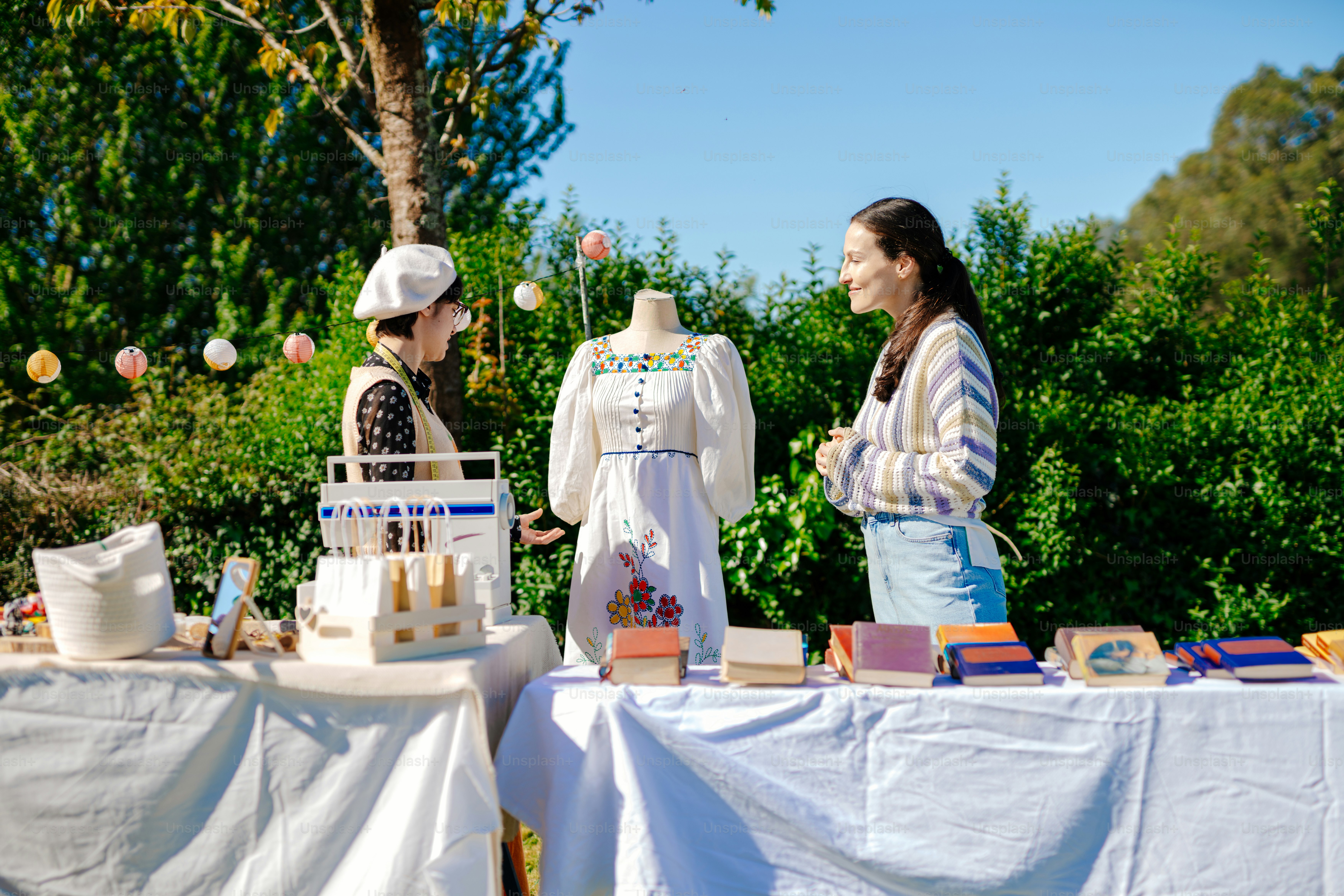 two women standing at a table with a cake on it