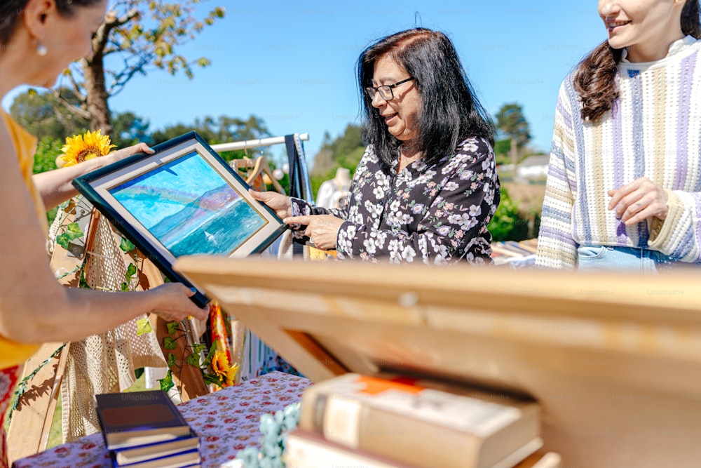 two women looking at a picture on a table