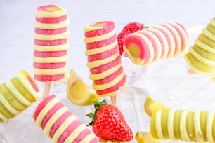 a group of fruit pops sitting on top of ice
