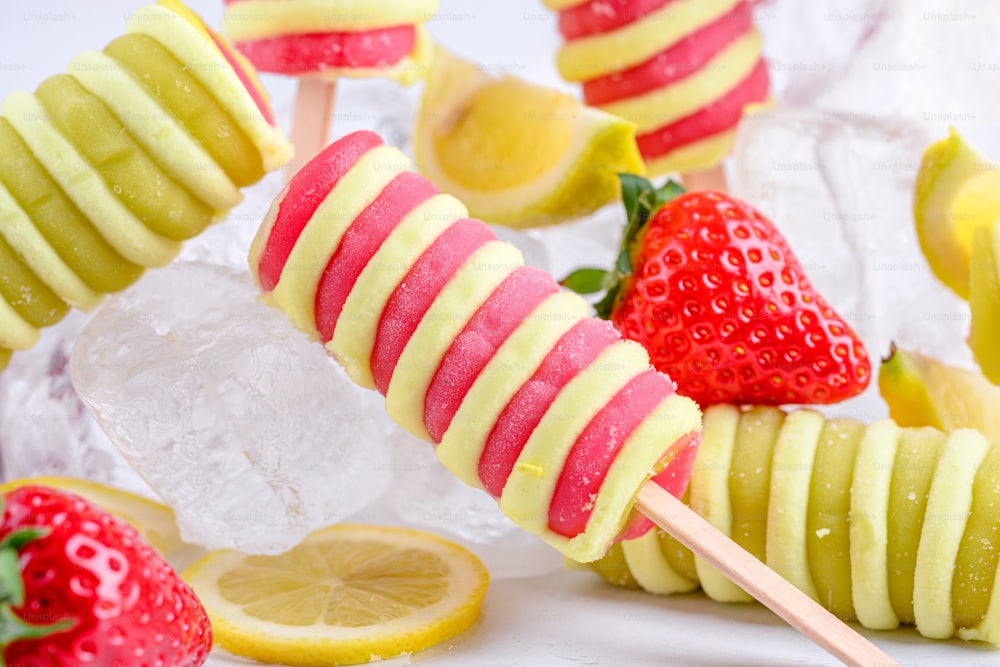 a close up of a fruit skewer with lemons and strawberries