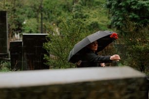 eine Frau, die einen Regenschirm über dem Kopf hält