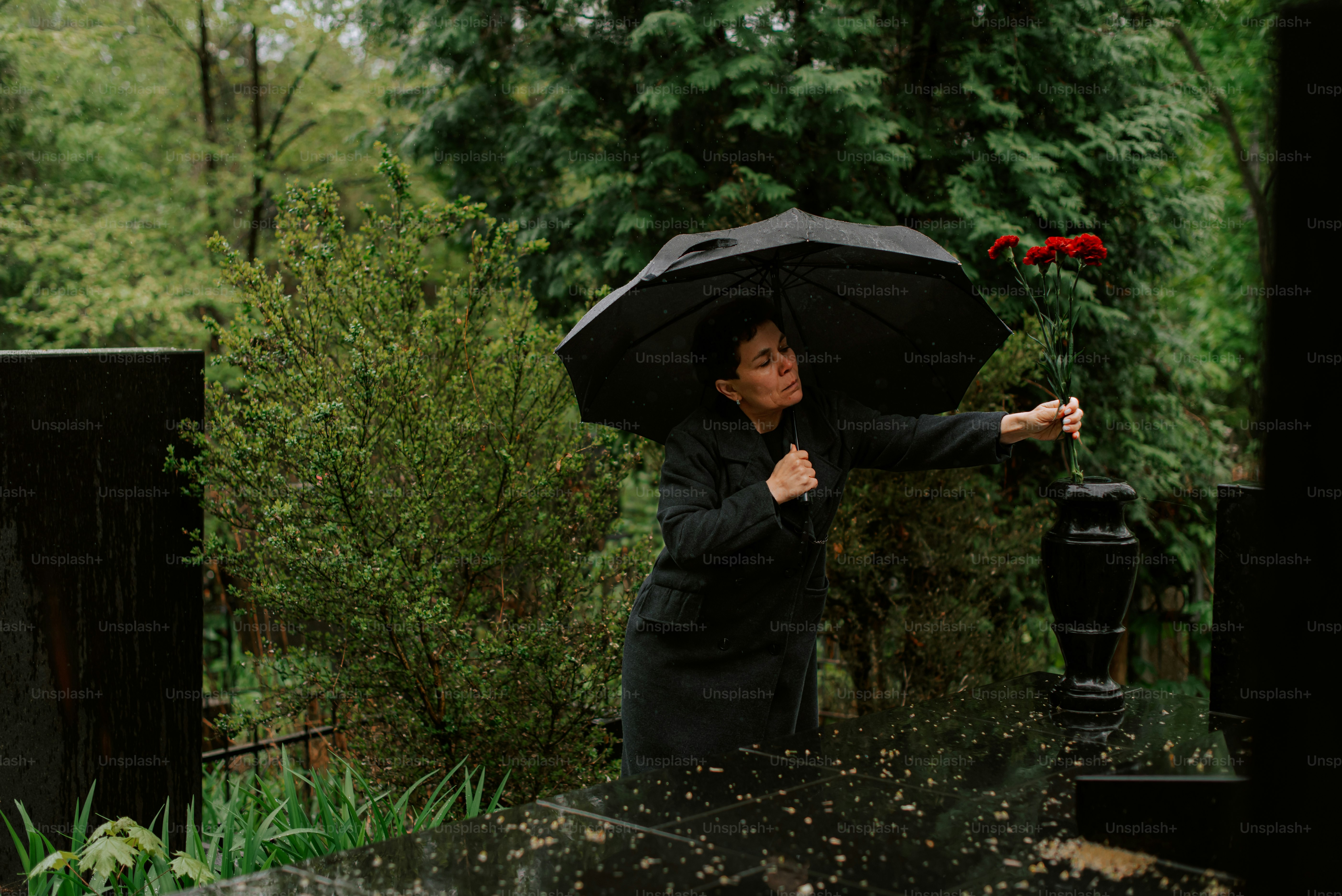 a woman holding a black umbrella over her head