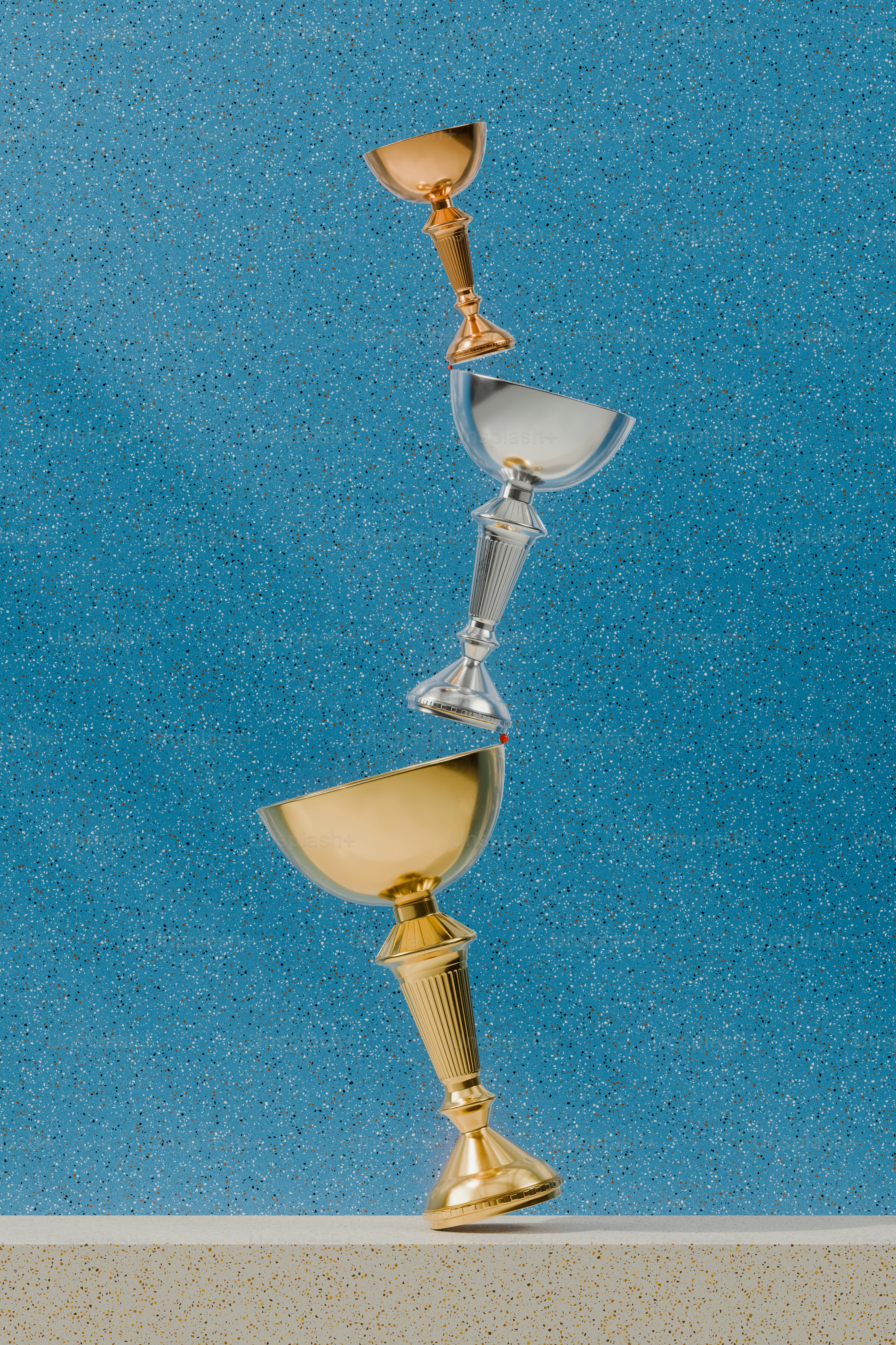 a golden cup and a silver cup on a table