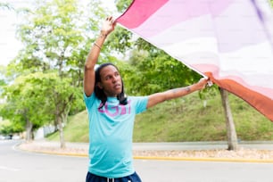 a woman holding a large pink and white flag