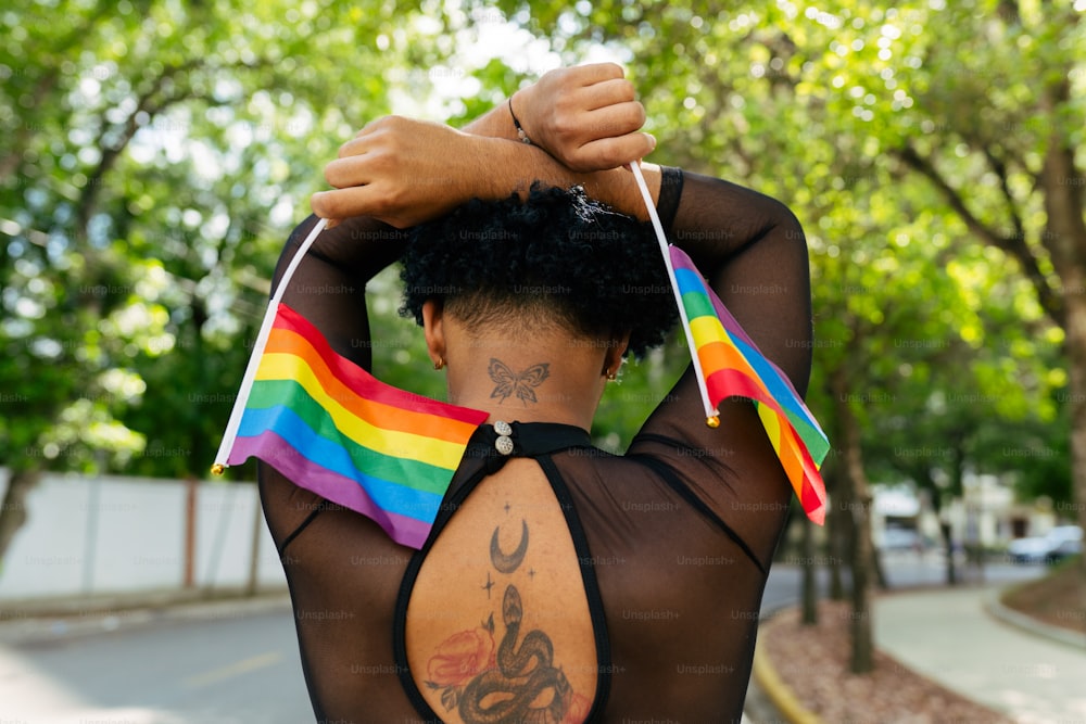 a woman with a rainbow flag on her back