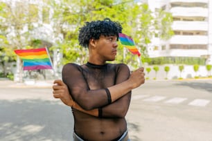 a woman holding a rainbow flag in the street