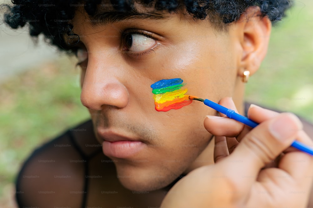 a man with a rainbow painted on his face
