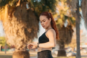 a woman with red hair wearing a black top