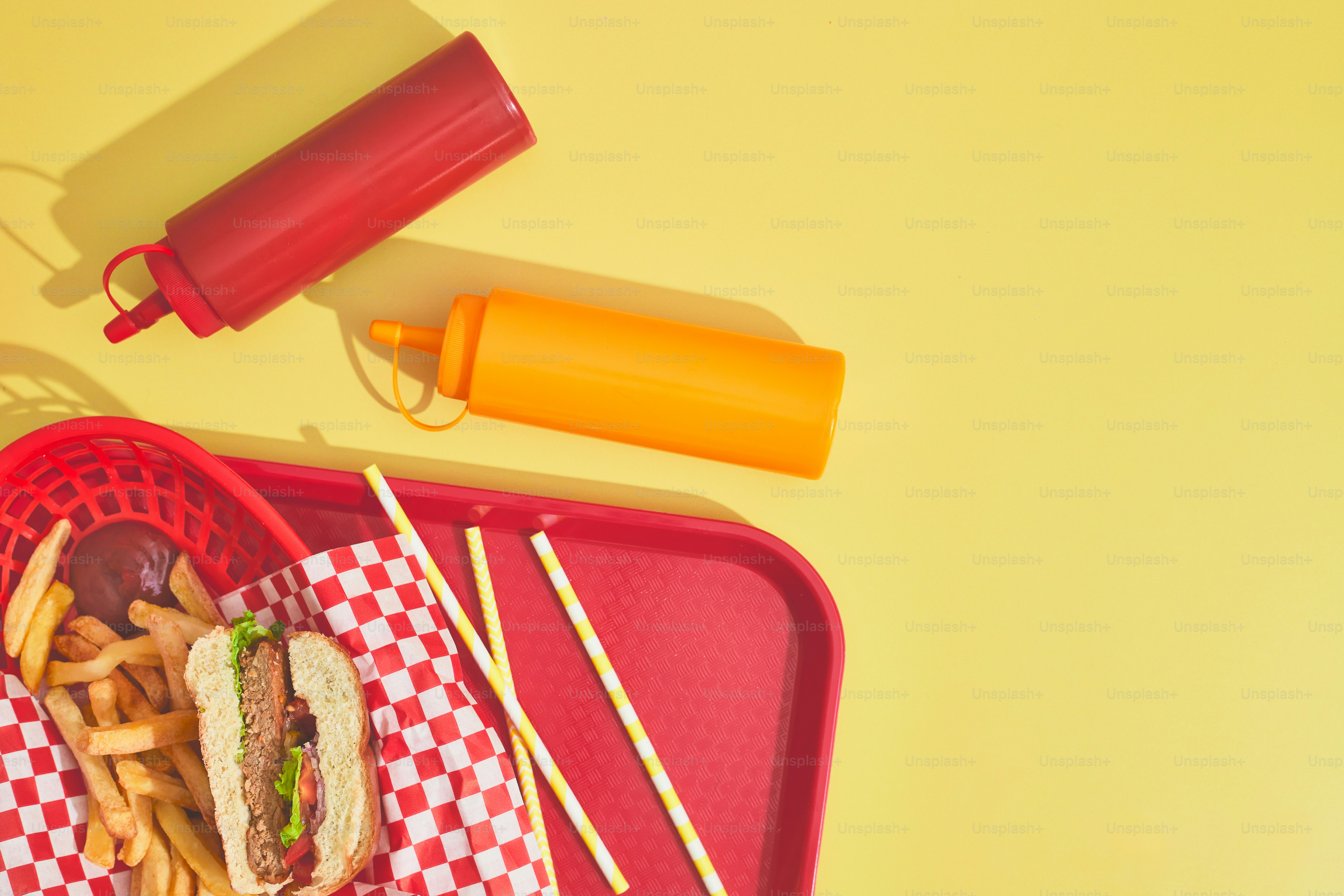 a red tray topped with a sandwich and fries