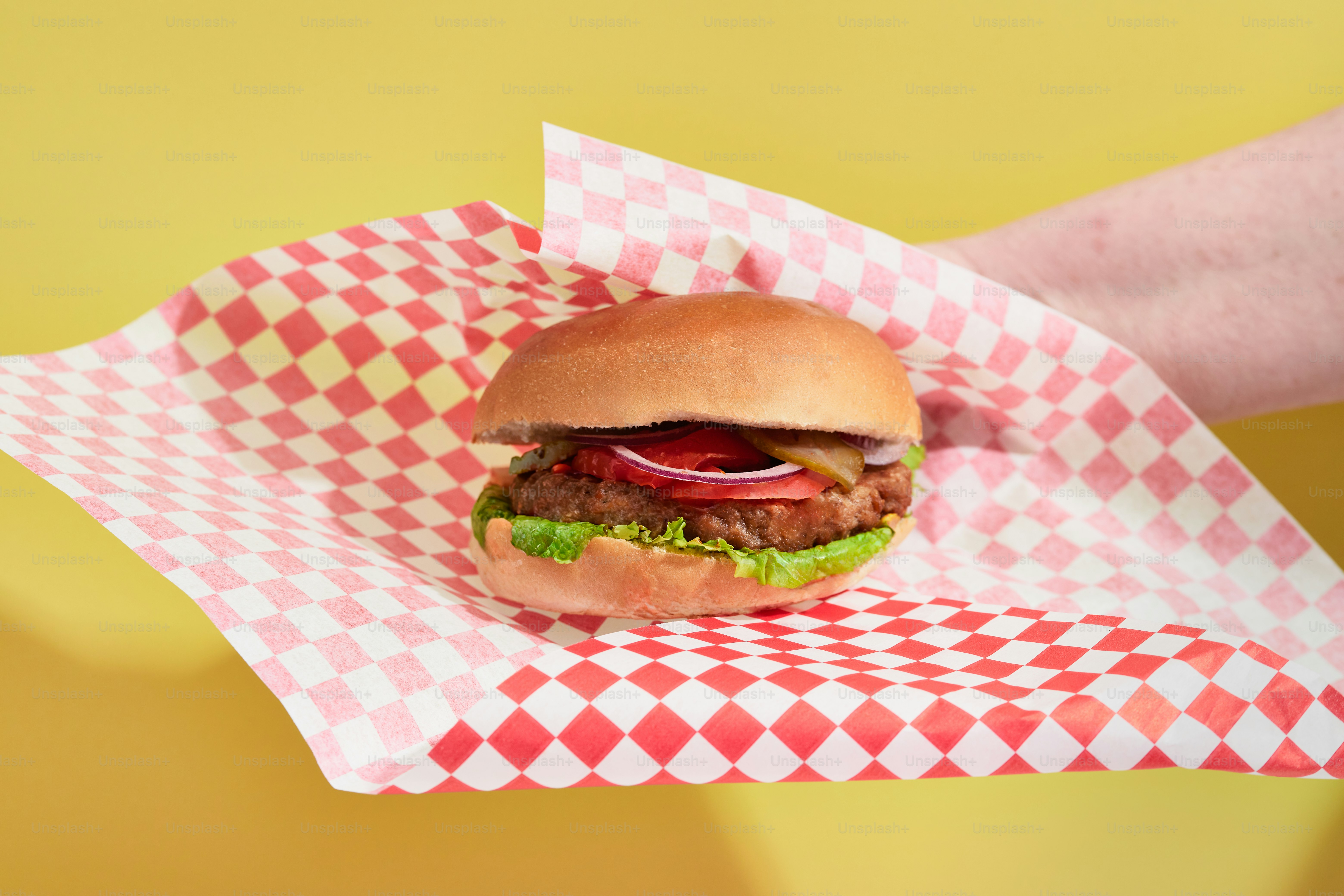 a hamburger with lettuce, tomato, and onions