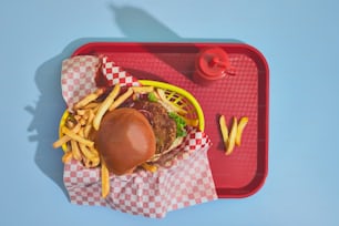 a tray with a hamburger and fries on it