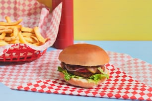 a hamburger sitting on top of a red and white checkered paper