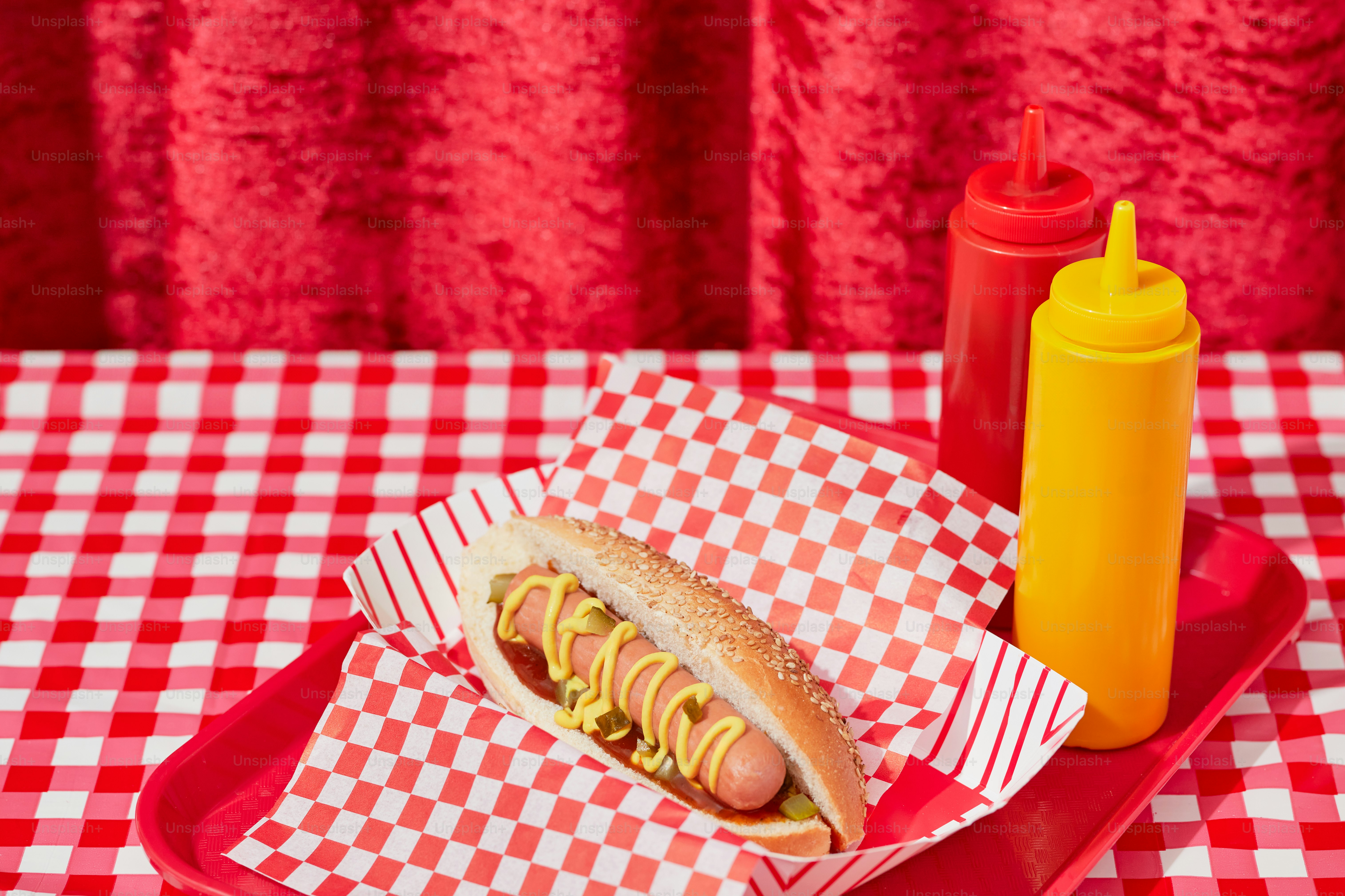 a hot dog with mustard and ketchup on a red tray