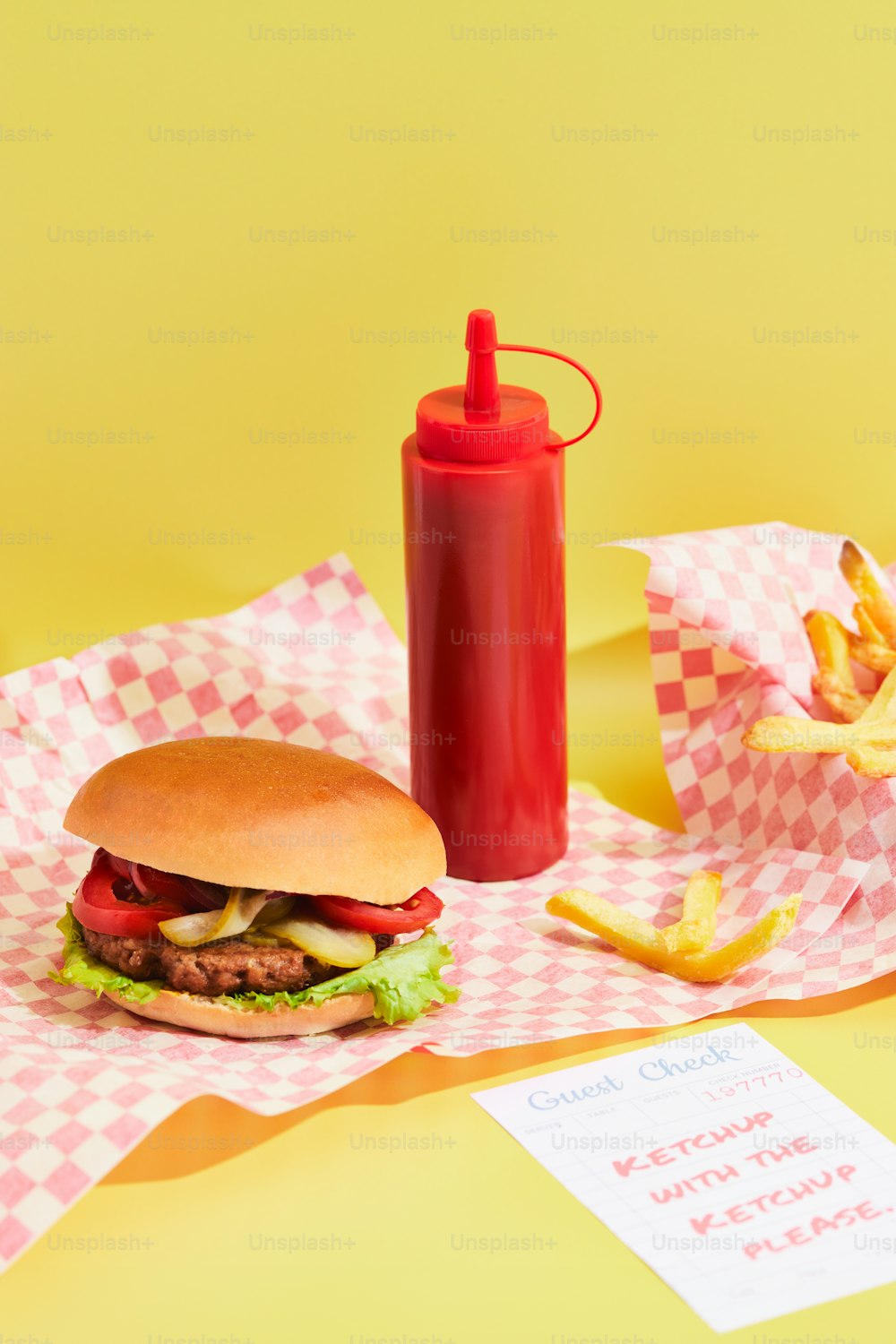 a hamburger and french fries on a yellow background
