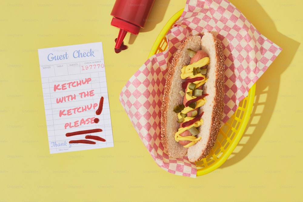 a hot dog sitting on top of a yellow basket