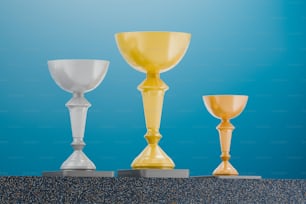 a group of three different colored glass goblets