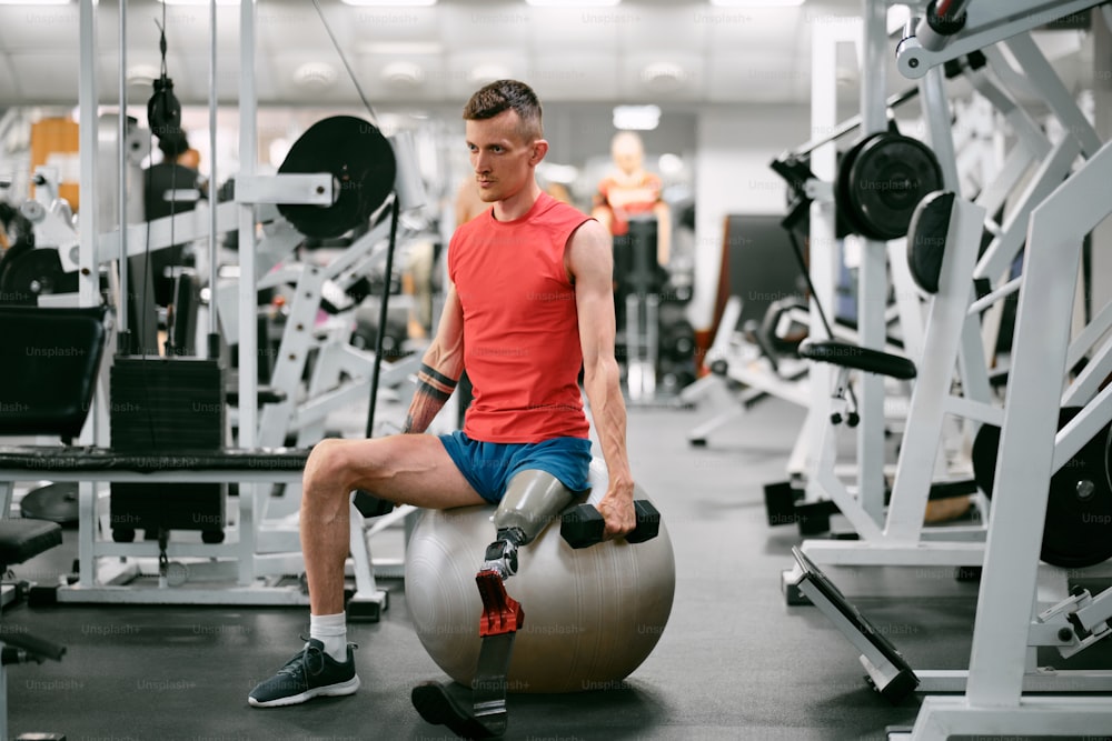 a man sitting on top of a gym ball