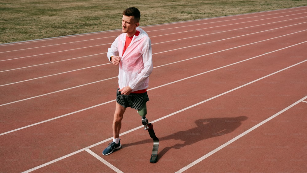 a man with a broken leg walking on a track