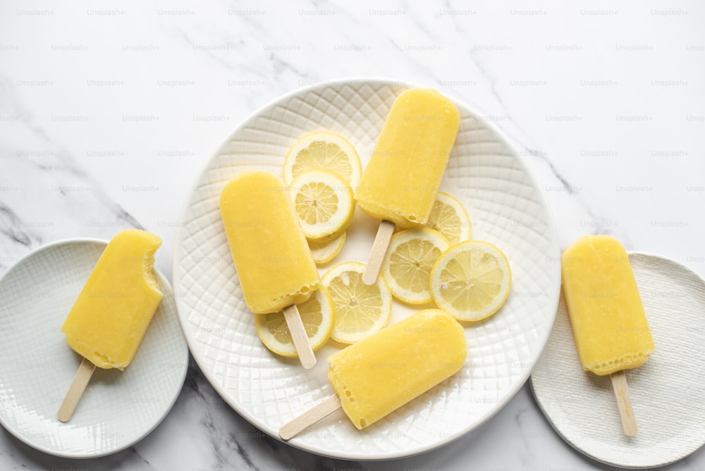 a white plate topped with slices of lemon