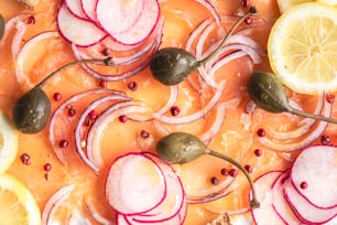 a close up of a plate of food with lemons and radishes