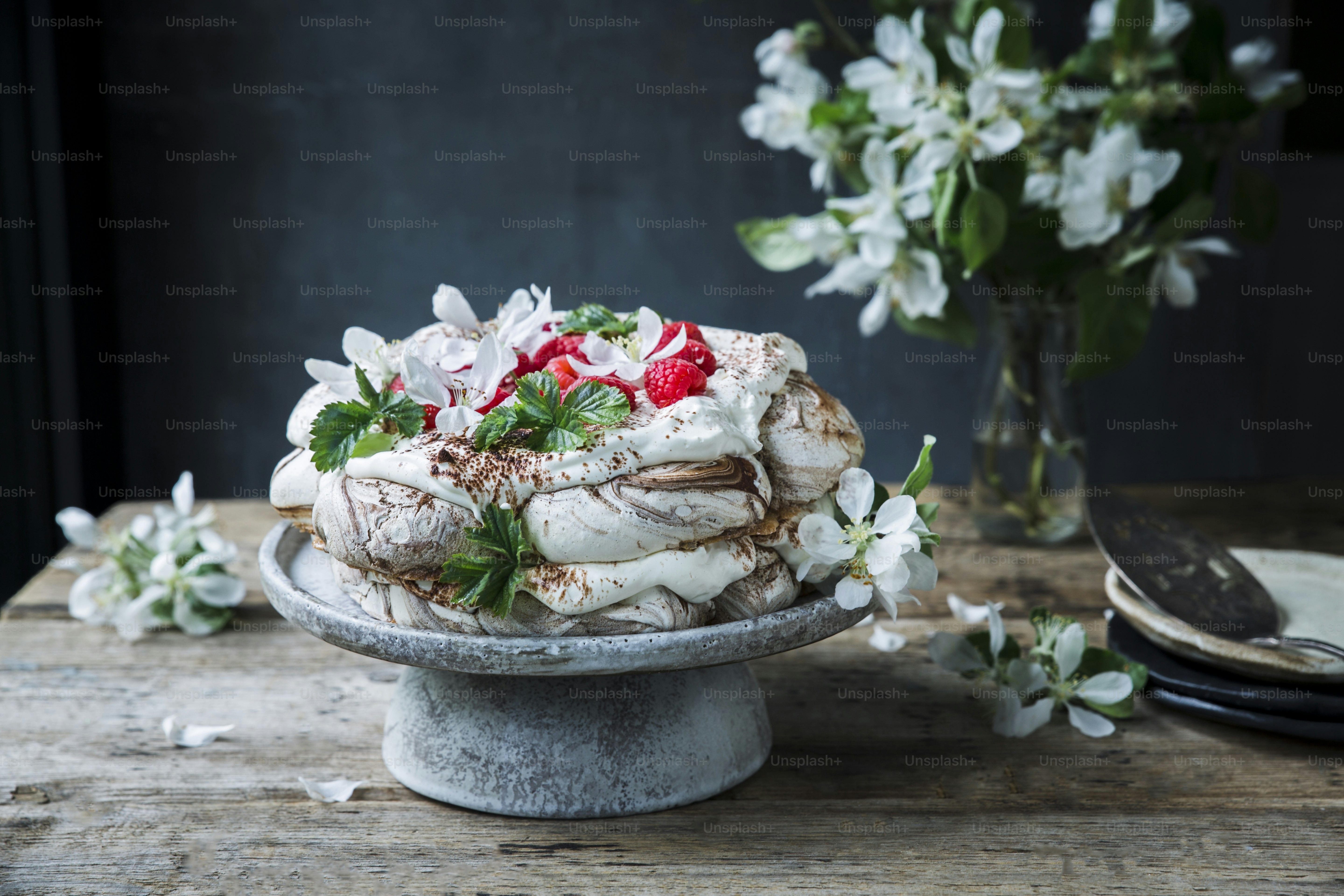 a cake on a plate with flowers in the background
