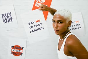 a woman with white hair holding up signs