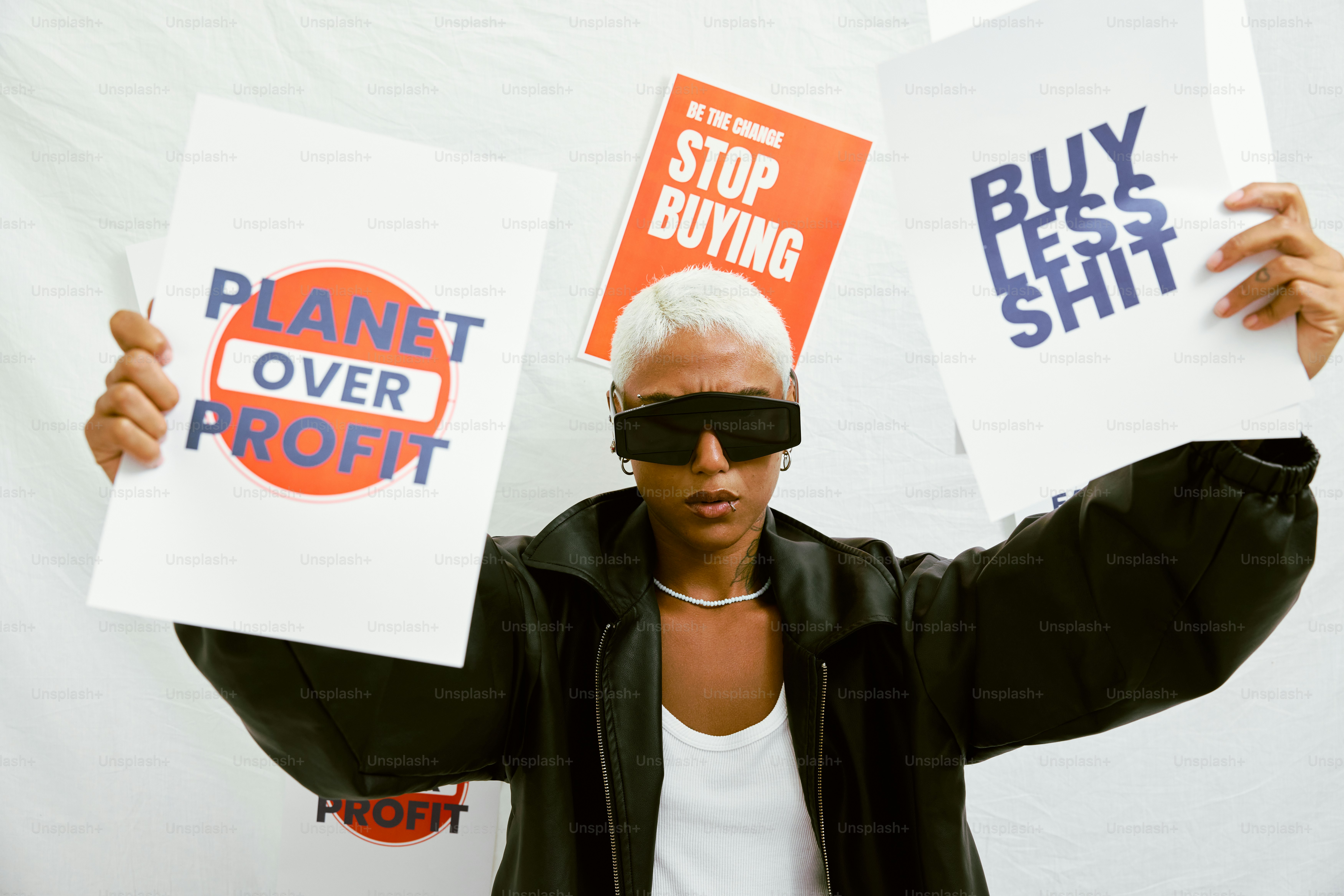 a woman holding up two signs in front of her face