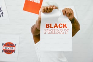 a man holding a sign that says black friday