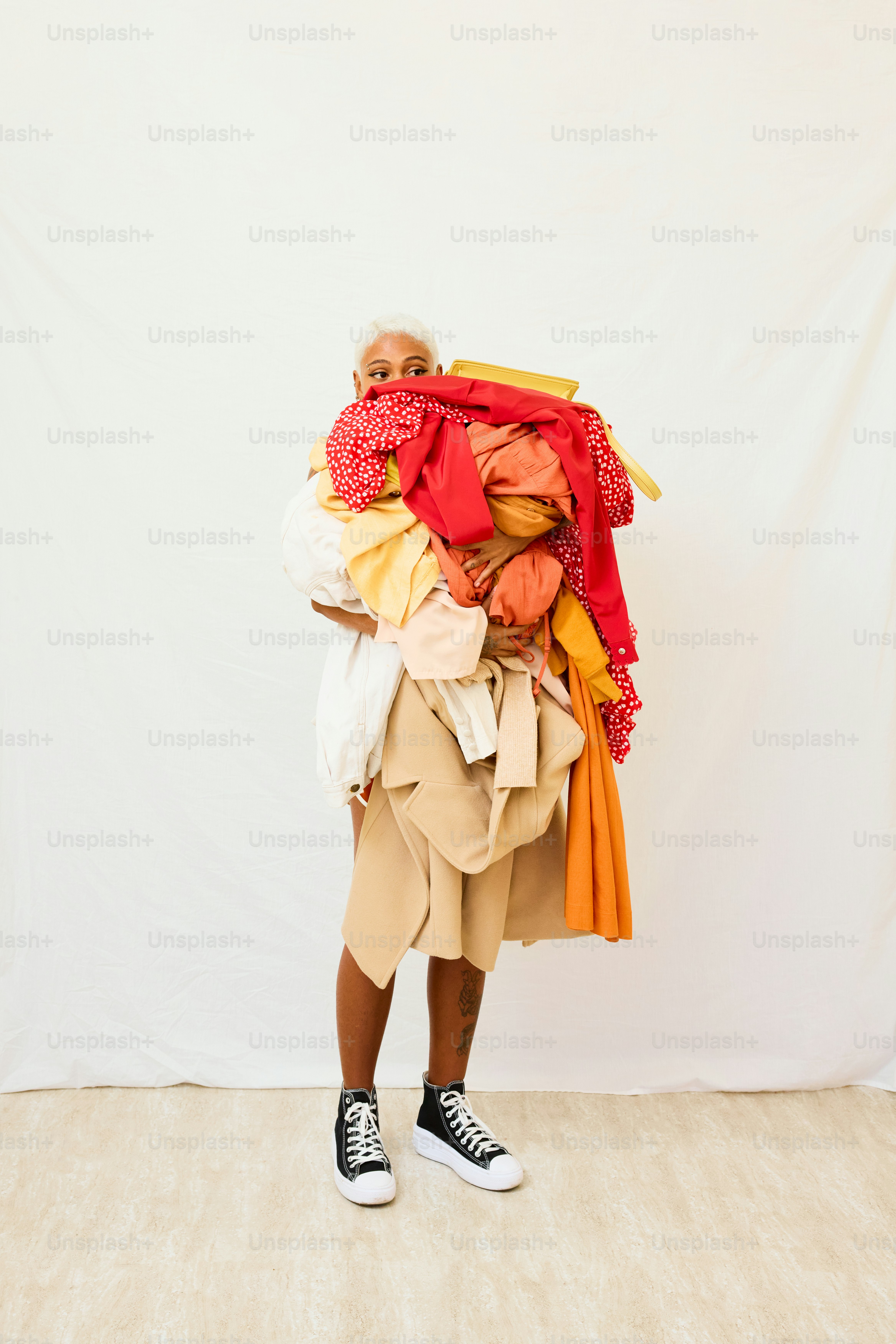 a man with a large pile of clothes on his back