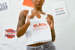 a woman holding a sign that says black friday