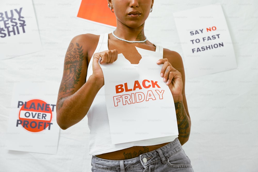 a woman holding a sign that says black friday