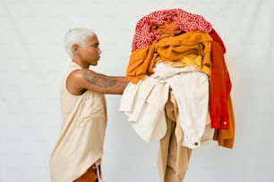 a man standing next to a pile of clothes