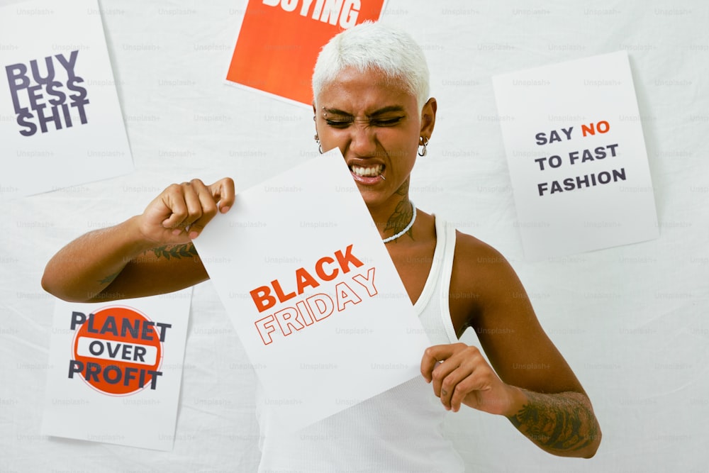 a woman holding a sign that says black friday