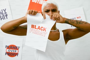 a man holding a piece of paper with the words black friday written on it