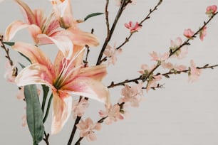 a vase filled with pink flowers on top of a table