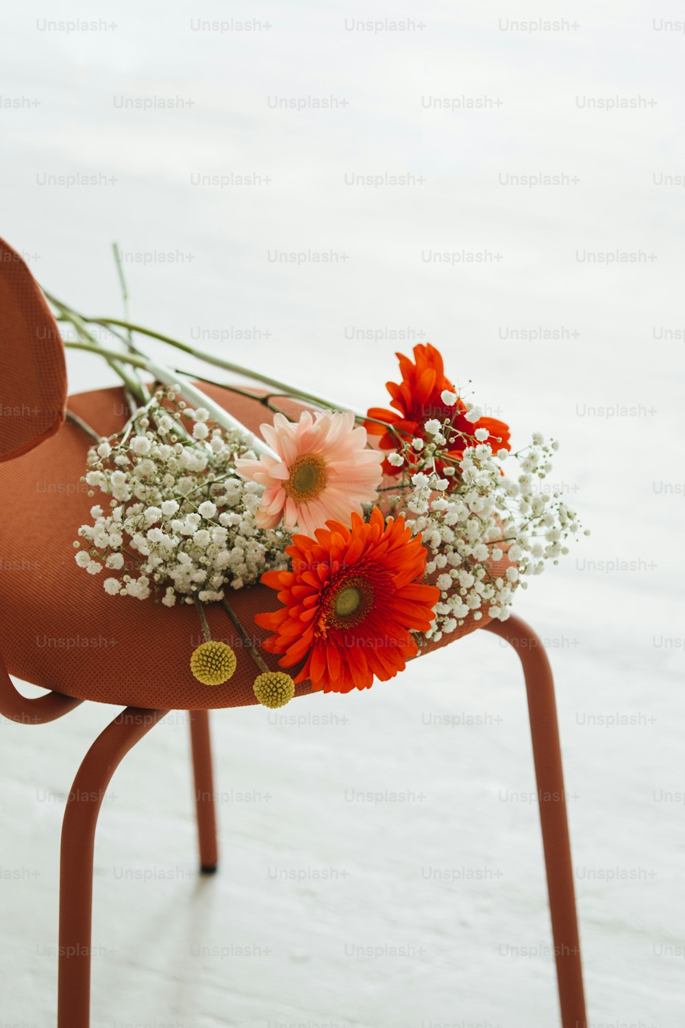 a chair with flowers on top of it