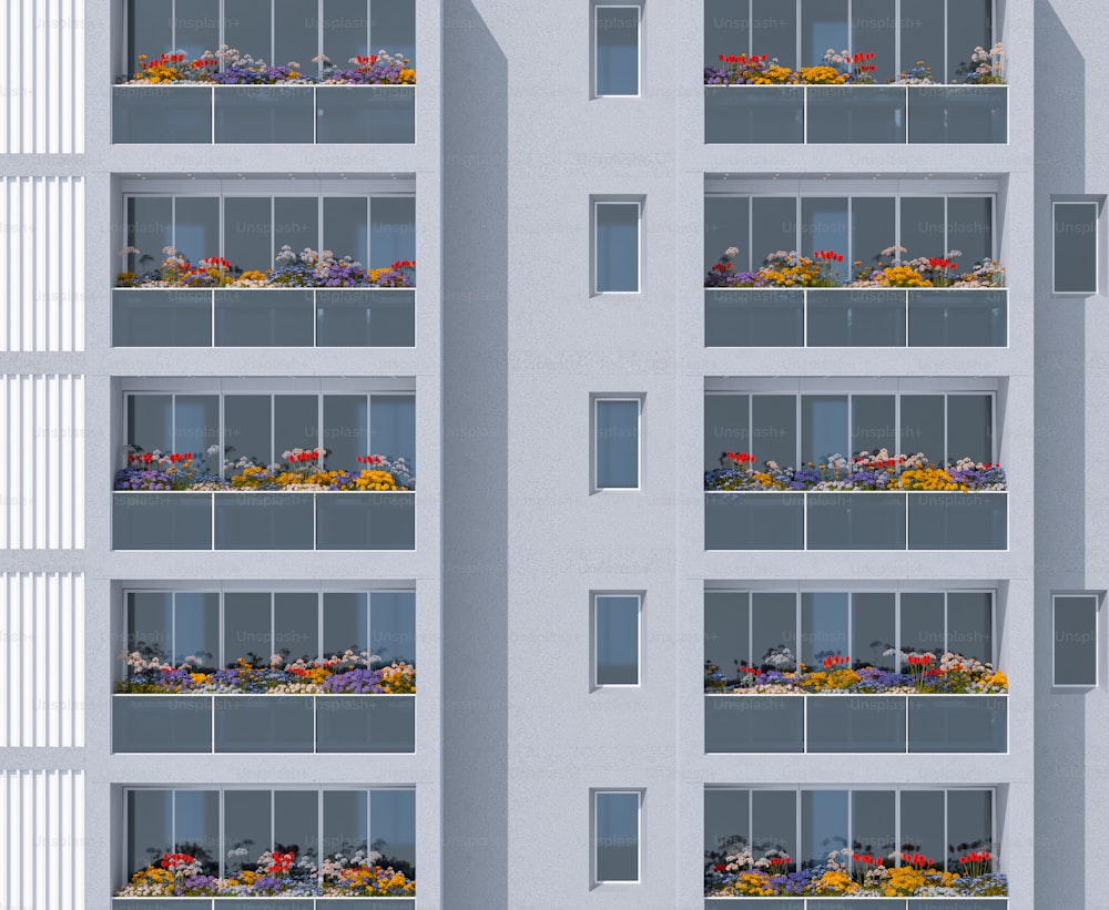 a tall white building with a bunch of flowers on the balconies