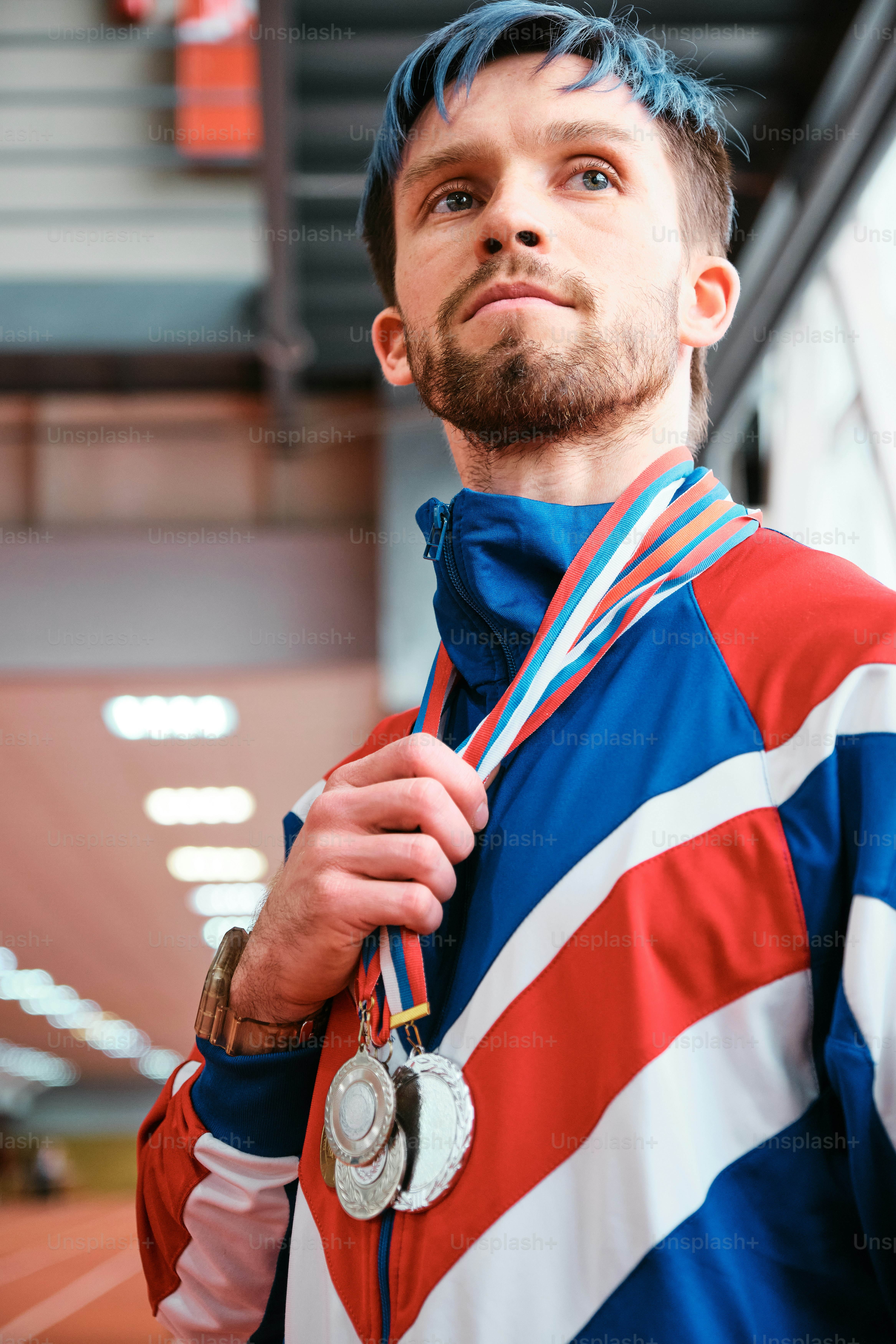 a man with blue hair and a medal around his neck