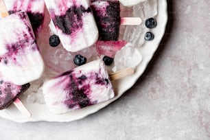 a white plate topped with blueberries and ice cream