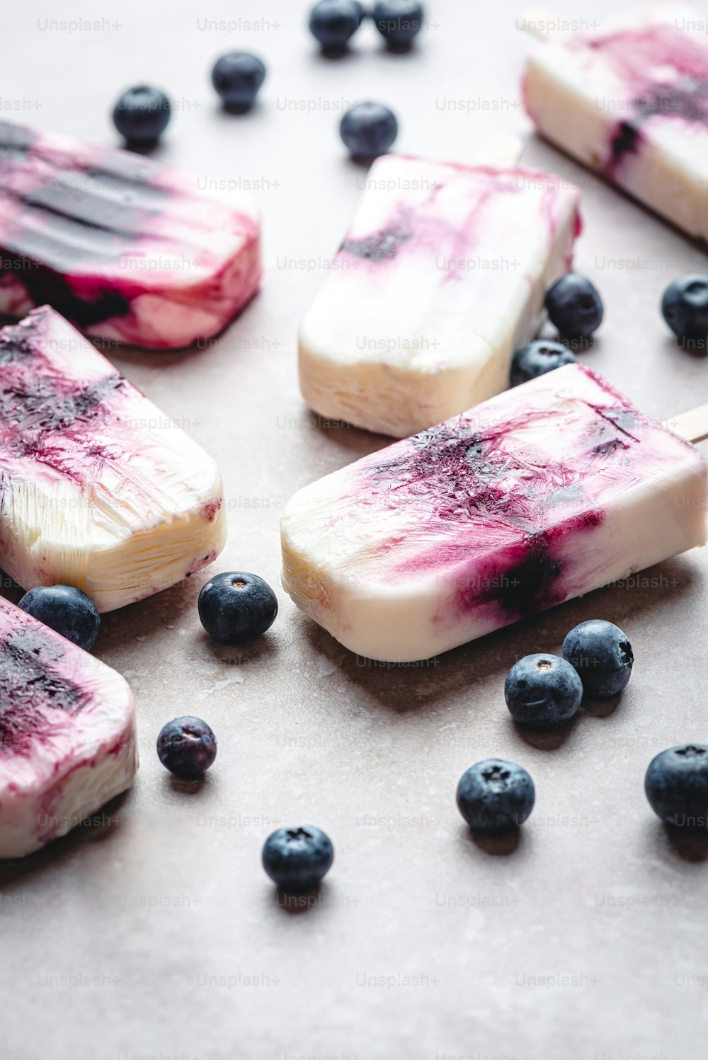 a close up of blueberry popsicles on a table
