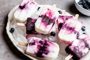 a white plate topped with blueberries and ice cream