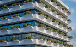 a very tall building with a bunch of plants on the balconies