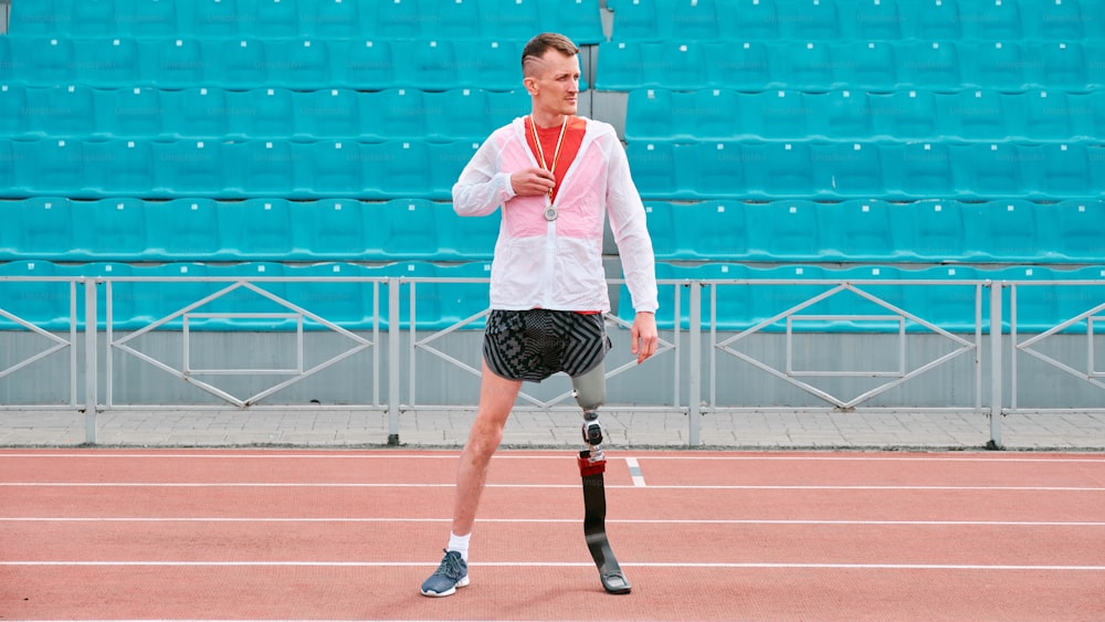 a man with a broken leg walking on a tennis court