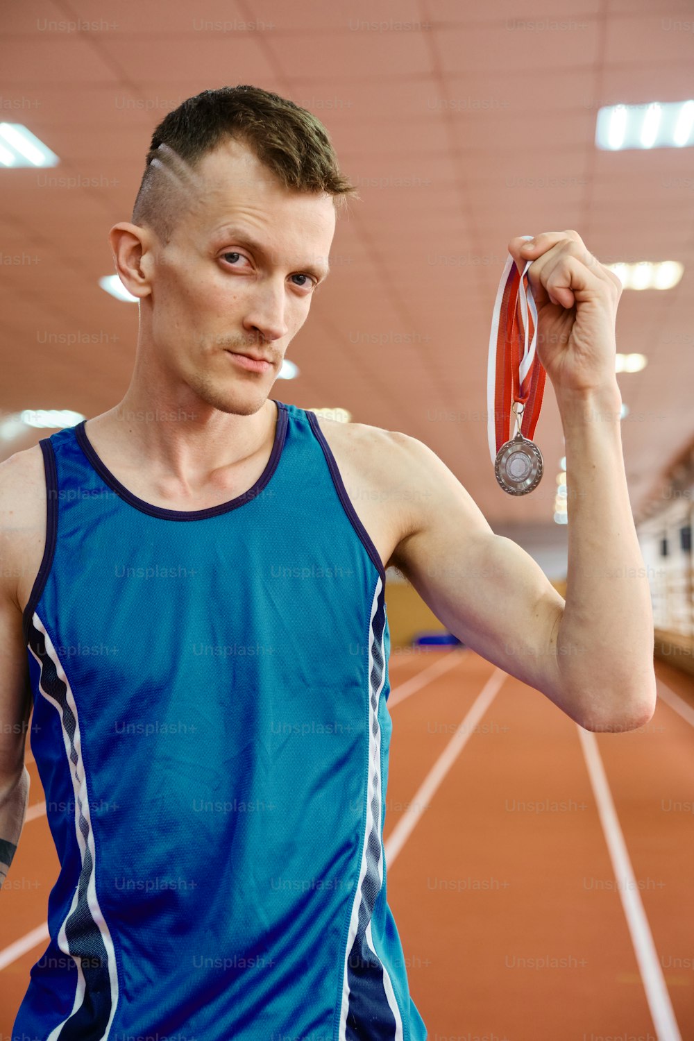 a man holding a medal and a medal in his hand