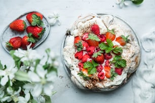 a cake with strawberries and whipped cream on top